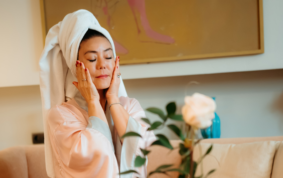 Lady cupping face with hands wearing a silk robe