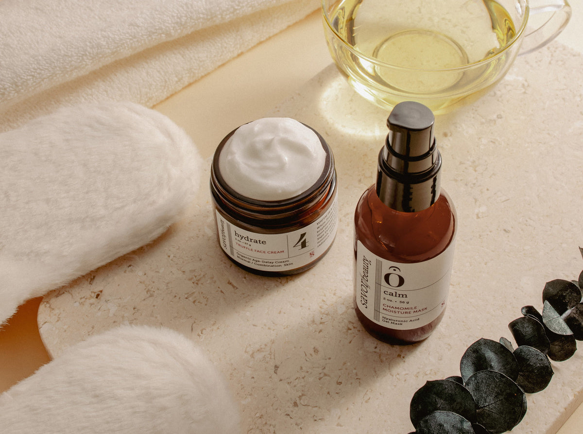 Savor Beauty skincare on a soft clean backround with tea and fuzzy slippers