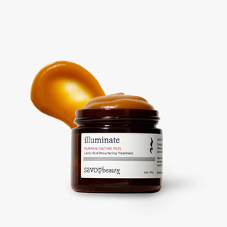 A jar of Savor Beauty illuminate Pumpkin Enzyme Peel treatment, showing the dark amber jar with a white label and a dollop of the golden-orange peel product on top, set against a clean white background.