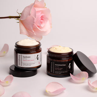 AM PM Rose Duo with open jars on white backdrop, soft pink rose petals and rose above