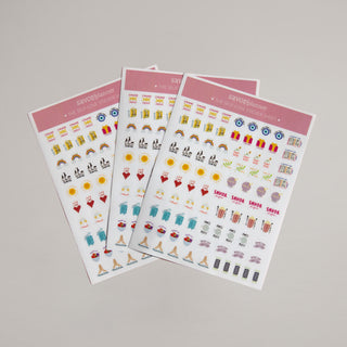 Three sheets of decorative stickers with various designs on a gray background