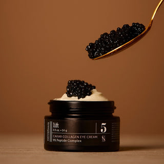 Black eye cream jar with caviar on a brown background