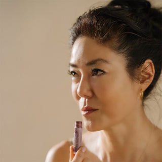 Angela Jia Kim applying tinted lip balm