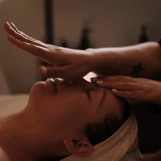 GIF of a relaxed spa guest receiving a facial massage 