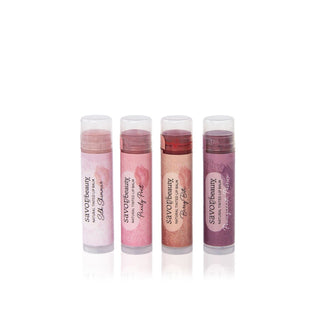 Four tinted lip balms standing in a row.