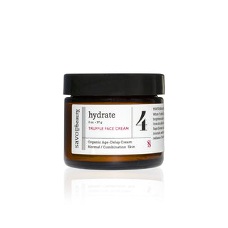 Jar of truffle face cream with a black lid on a white background