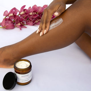 Person applying swatch of chardonnay body cream to legs